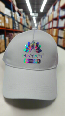 white cap with colorful logo and text on a warehouse floor